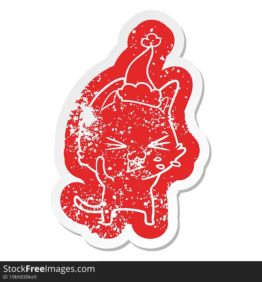 cartoon distressed sticker of a cat hissing wearing santa hat