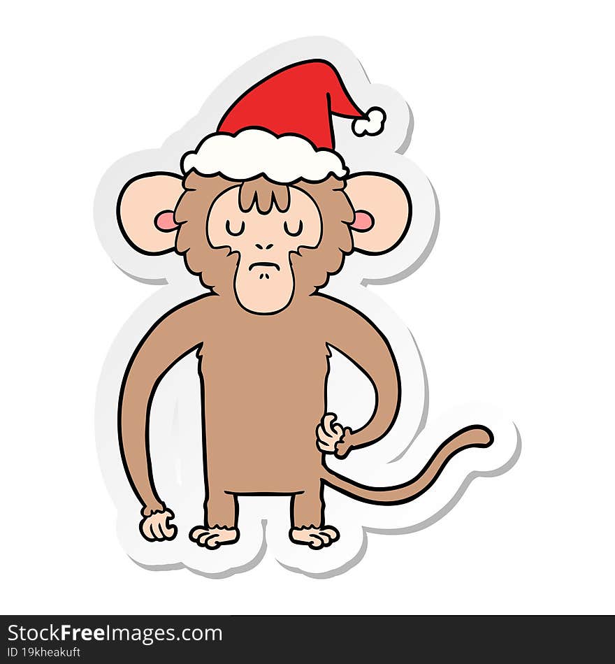 hand drawn sticker cartoon of a monkey scratching wearing santa hat