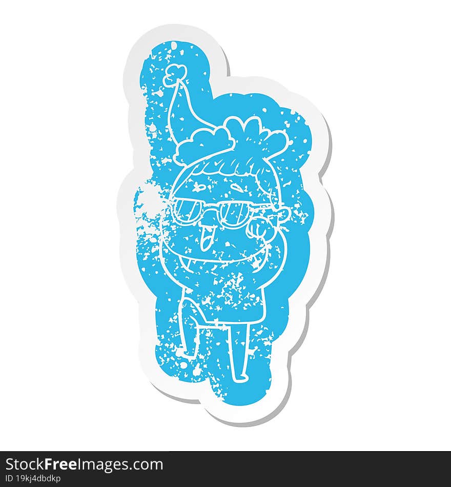 Cartoon Distressed Sticker Of A Happy Woman Wearing Spectacles Wearing Santa Hat