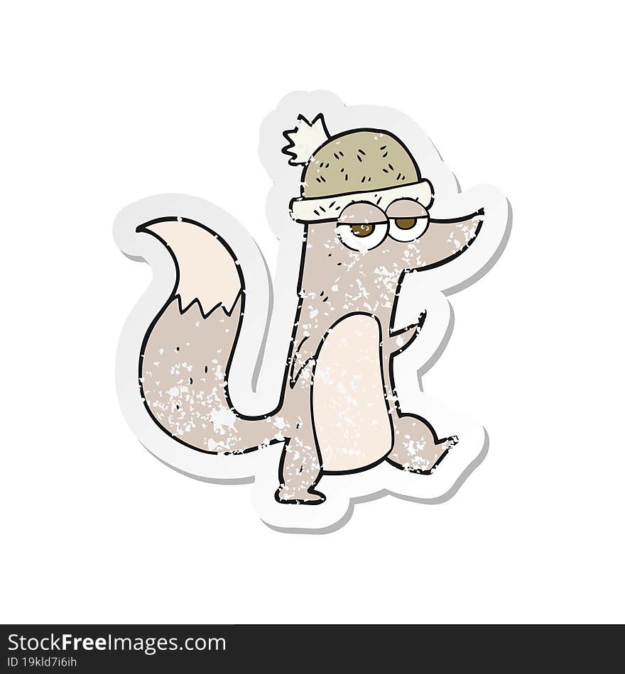 retro distressed sticker of a cartoon little wolf wearing hat