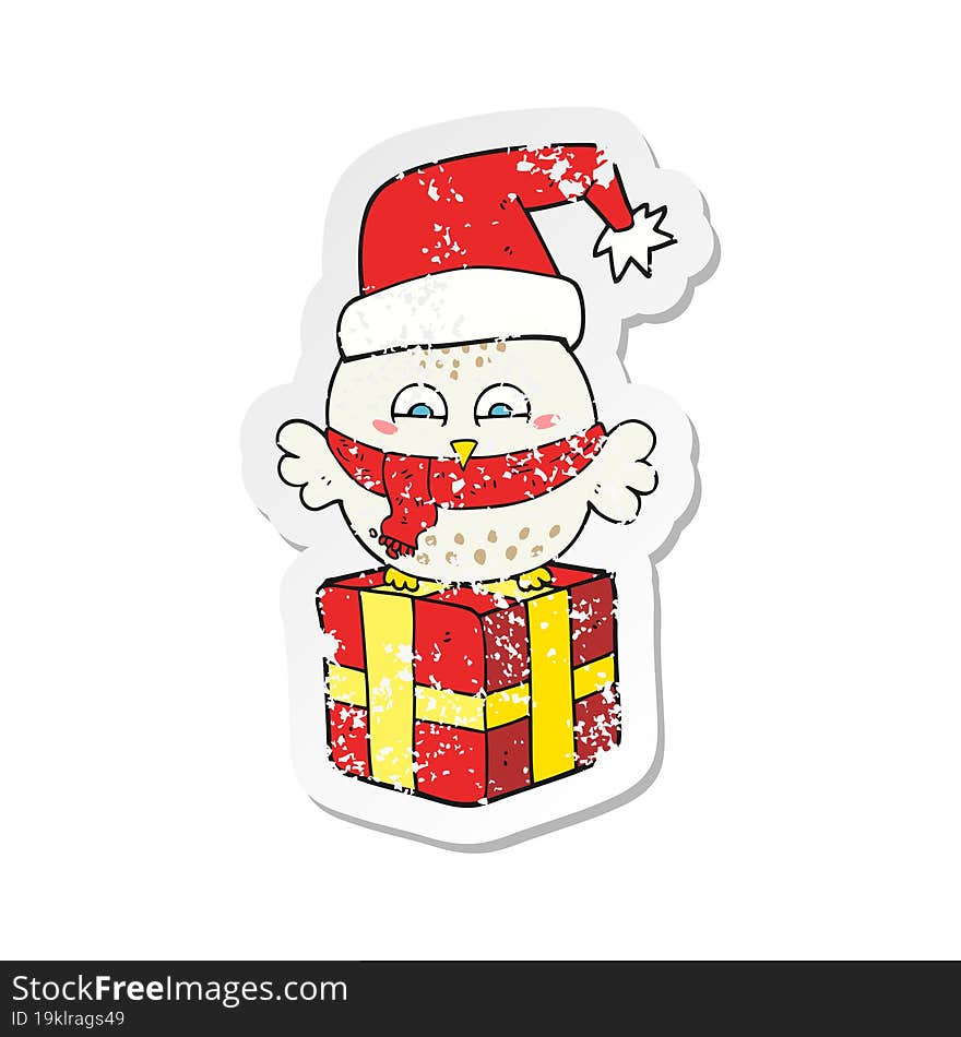 retro distressed sticker of a cartoon cute christmas owl on gift