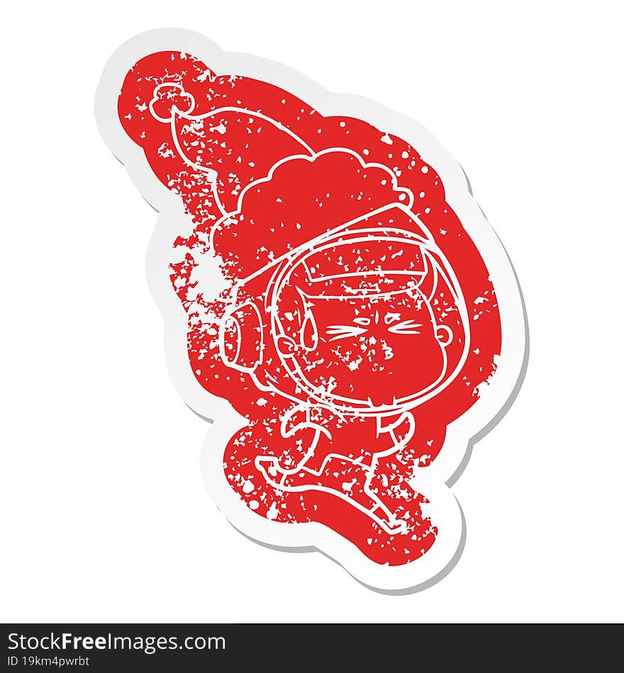 cartoon distressed sticker of a stressed astronaut wearing santa hat