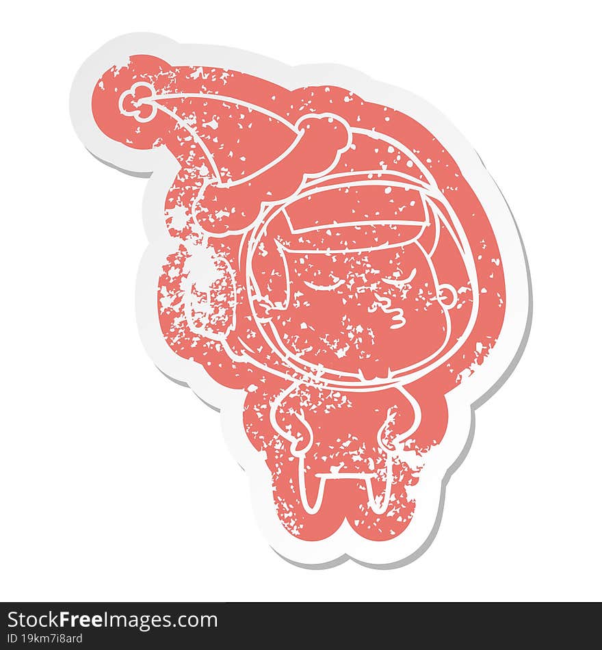 cartoon distressed sticker of a confident astronaut wearing santa hat