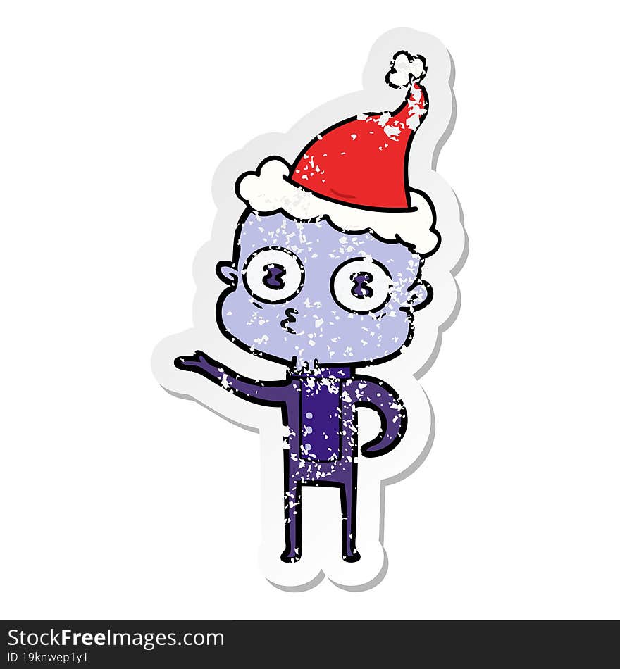 distressed sticker cartoon of a weird bald spaceman wearing santa hat