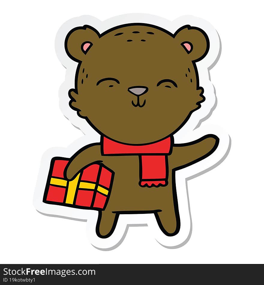 sticker of a happy cartoon bear with present