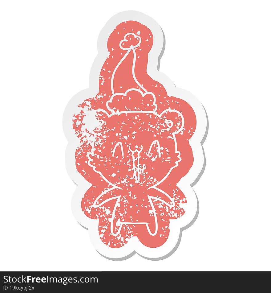 happy polar bear quirky cartoon distressed sticker of a wearing santa hat