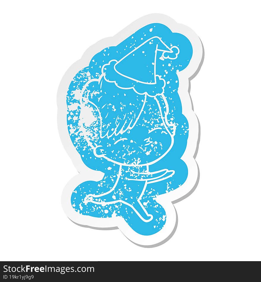 cartoon distressed sticker of a girl in onesie wearing santa hat