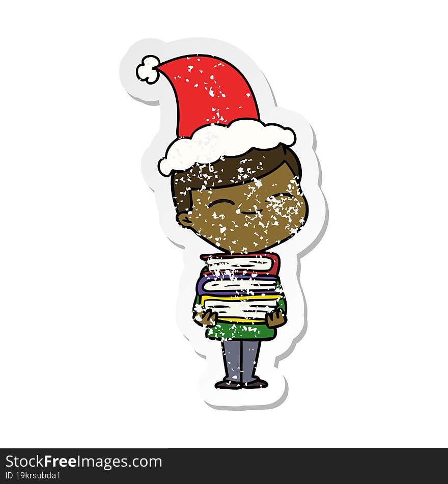 distressed sticker cartoon of a smiling boy with stack of books wearing santa hat