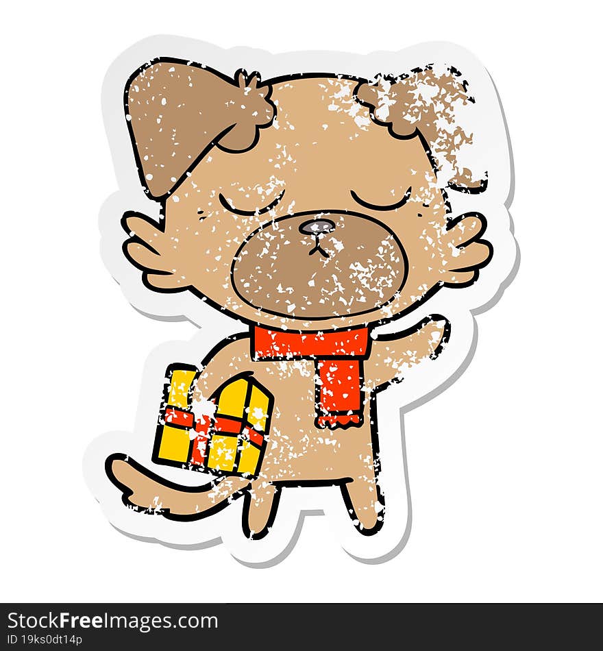 distressed sticker of a cute cartoon dog with christmas present