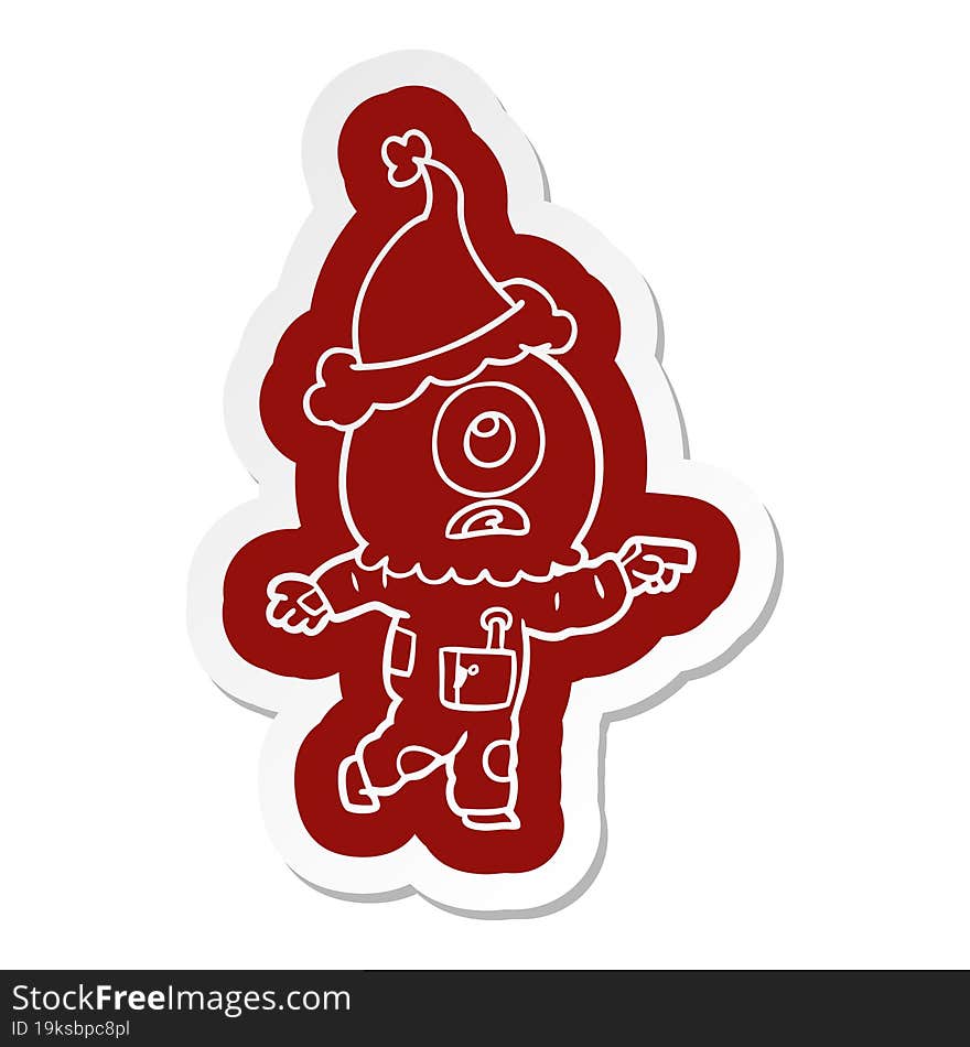 cartoon  sticker of a cyclops alien spaceman pointing wearing santa hat