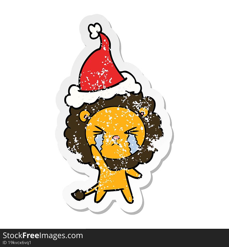 distressed sticker cartoon of a crying lion wearing santa hat