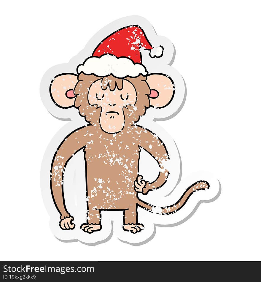 Distressed Sticker Cartoon Of A Monkey Scratching Wearing Santa Hat