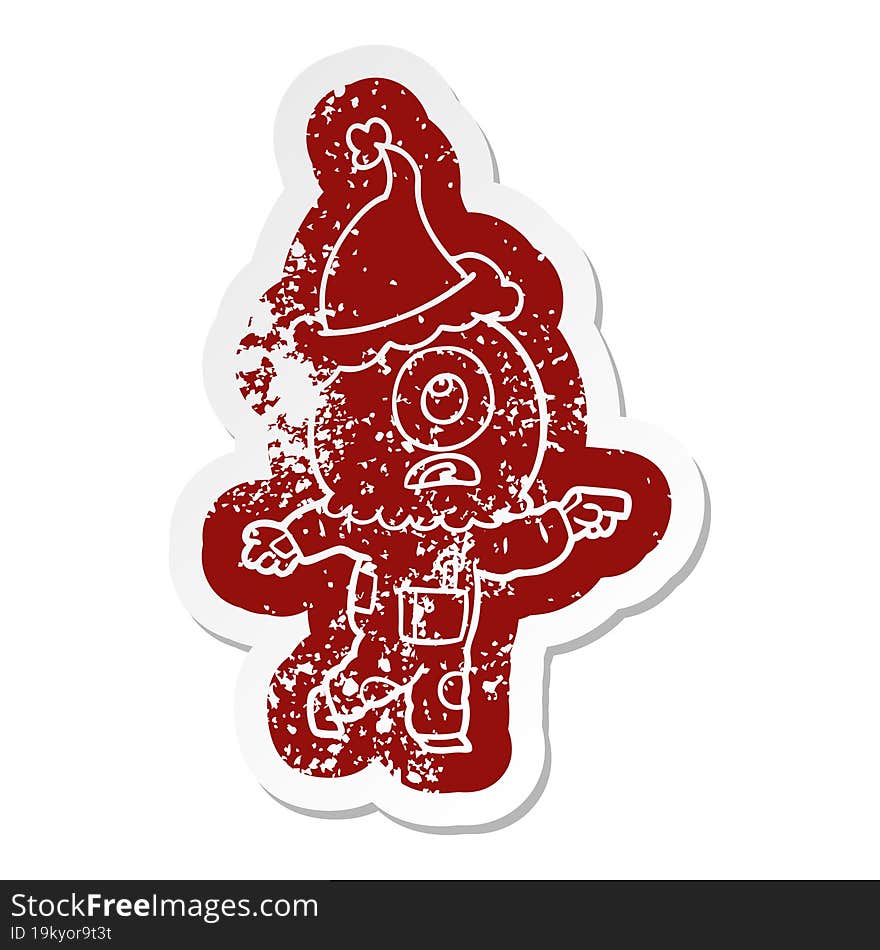 quirky cartoon distressed sticker of a cyclops alien spaceman pointing wearing santa hat