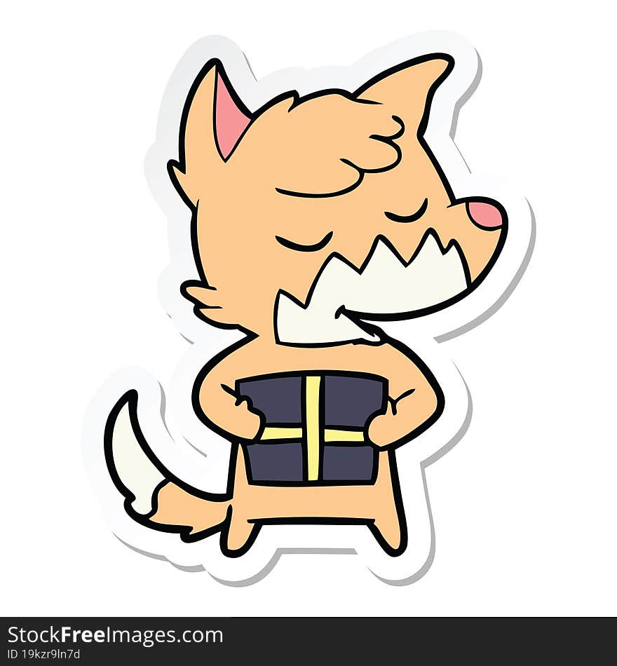 sticker of a friendly cartoon fox with christmas present