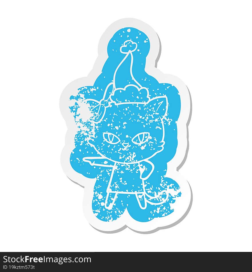 cute cartoon distressed sticker of a cat wearing dress wearing santa hat