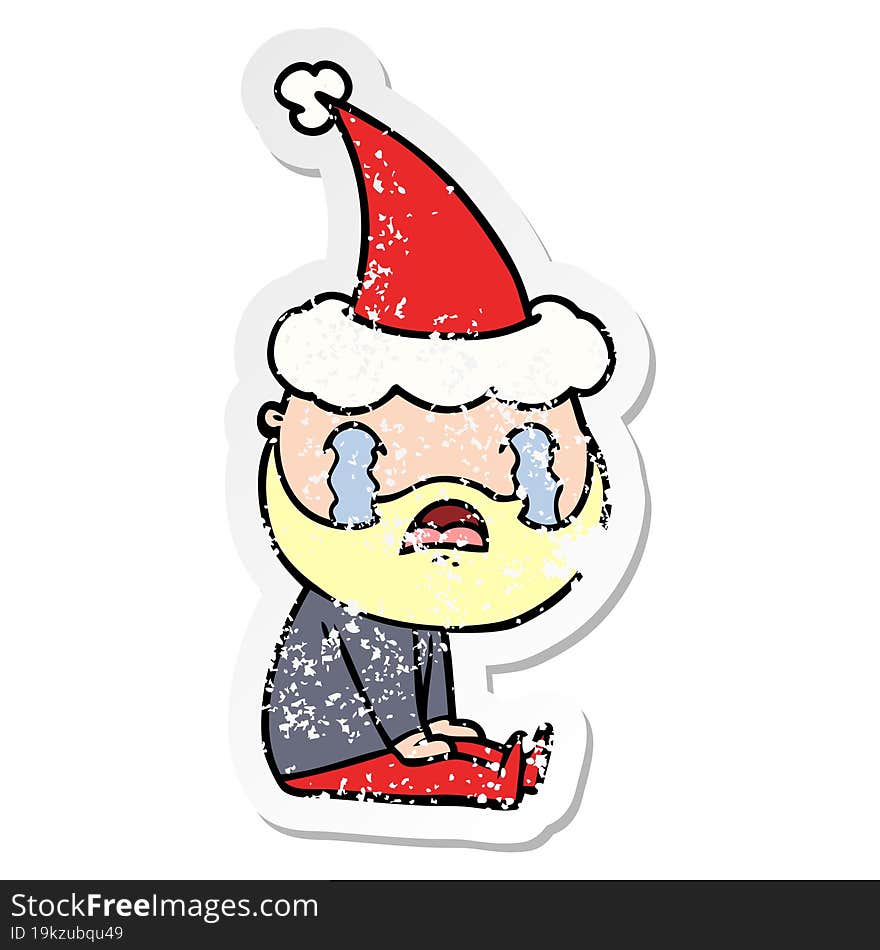 distressed sticker cartoon of a bearded man crying wearing santa hat