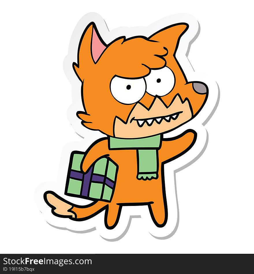 sticker of a cartoon grinning fox with christmas present