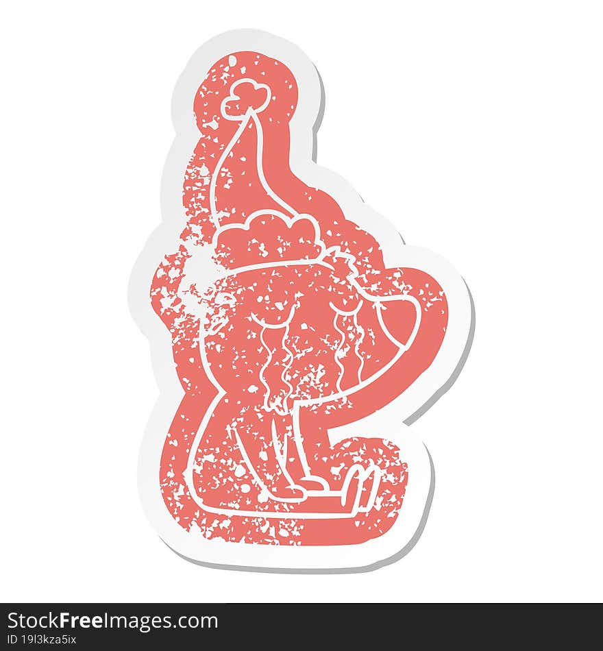 cartoon distressed sticker of a crying sitting polar bear wearing santa hat