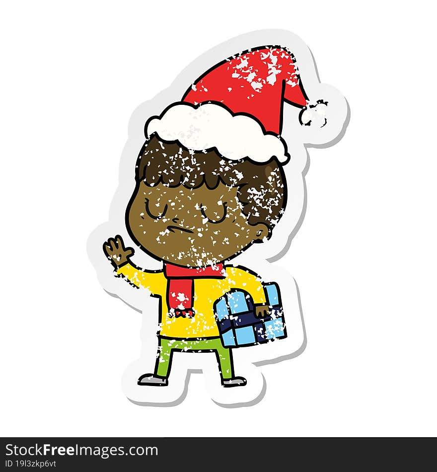 distressed sticker cartoon of a grumpy boy wearing santa hat