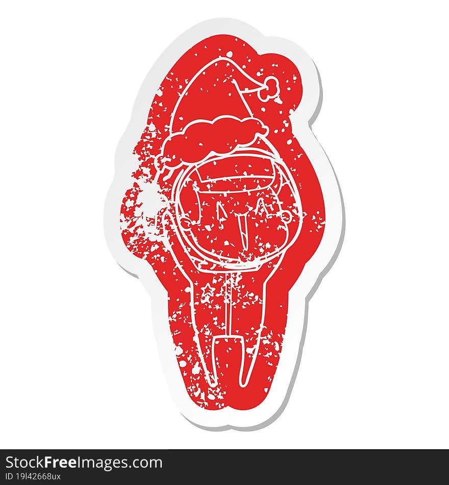 Happy Cartoon Distressed Sticker Of A Astronaut Wearing Santa Hat