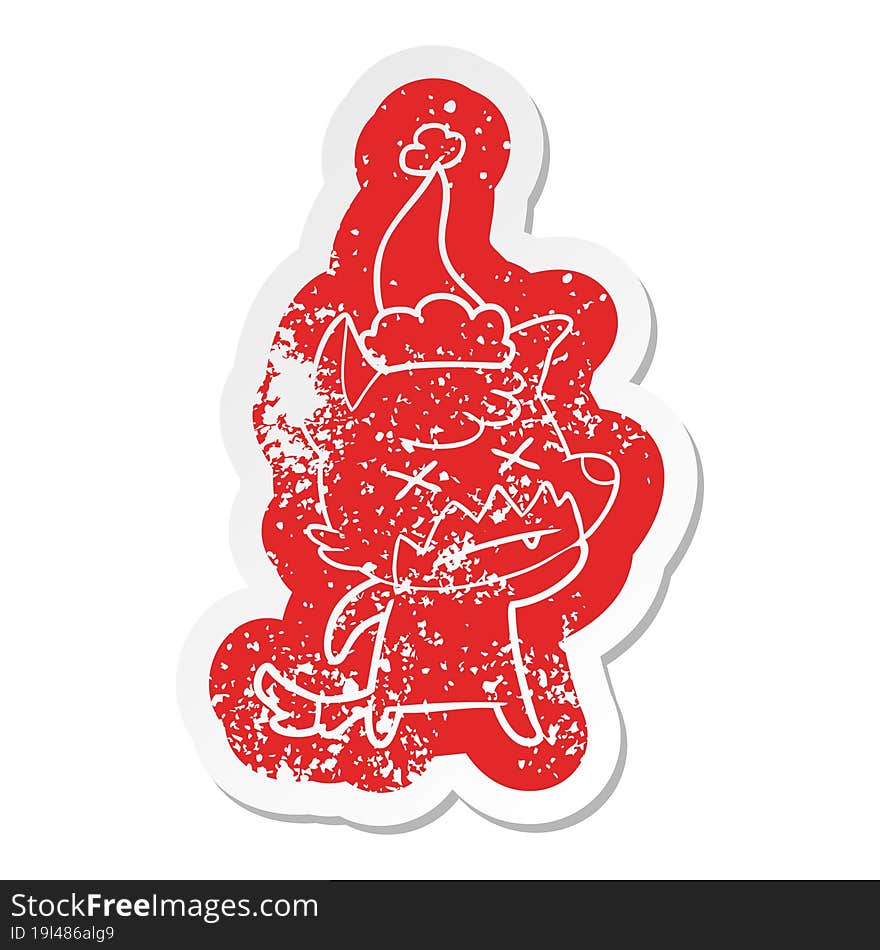 cartoon distressed sticker of a dead fox wearing santa hat