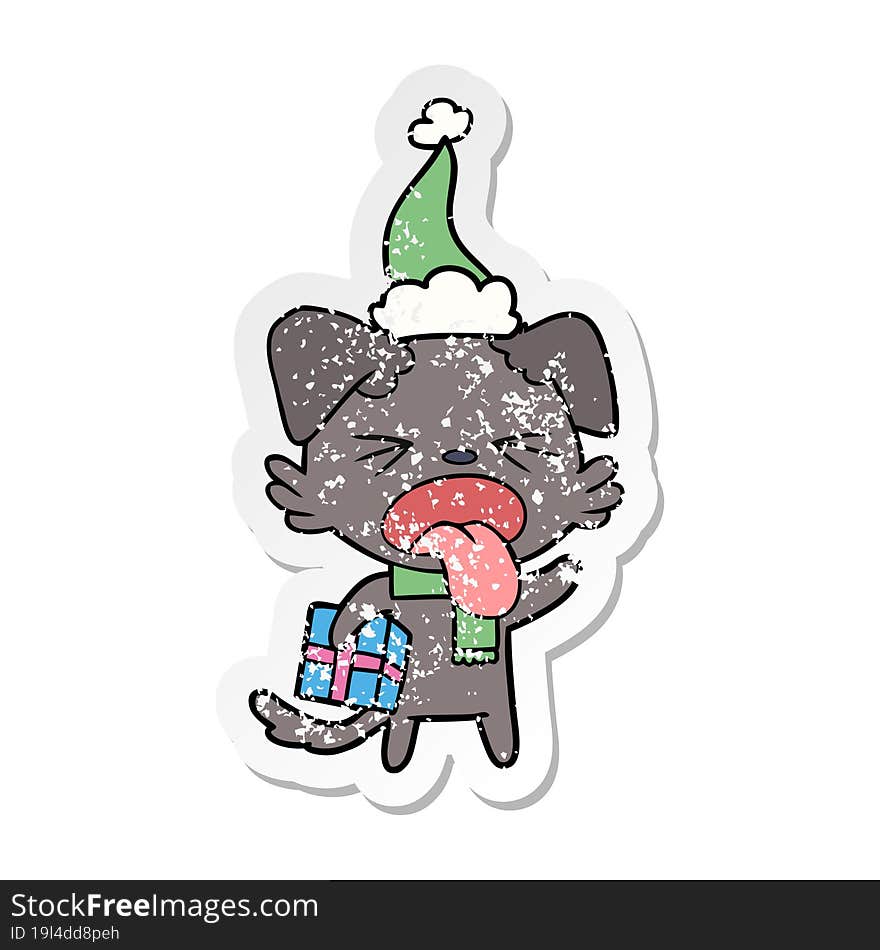 Distressed Sticker Cartoon Of A Disgusted Dog With Christmas Gift Wearing Santa Hat