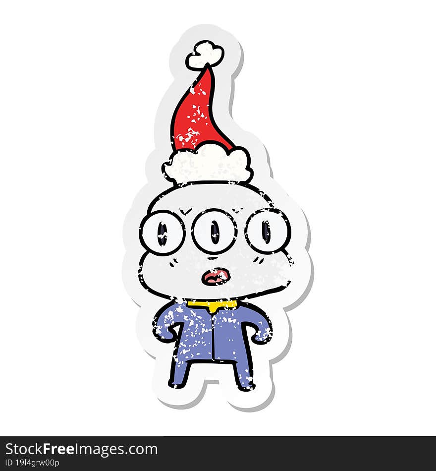 distressed sticker cartoon of a three eyed alien wearing santa hat