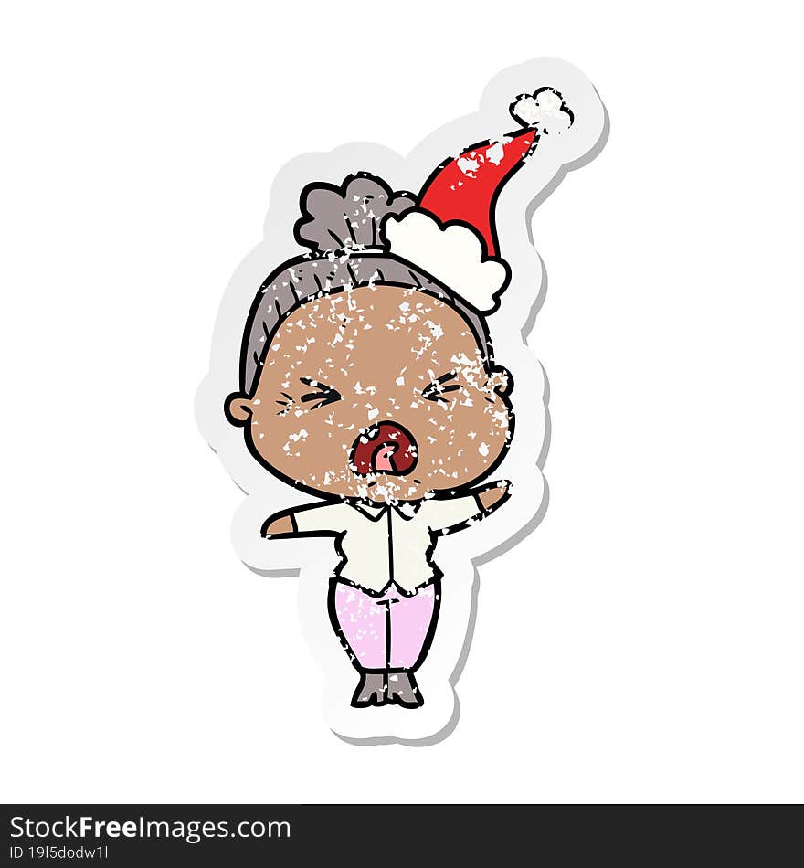 hand drawn distressed sticker cartoon of a angry old woman wearing santa hat