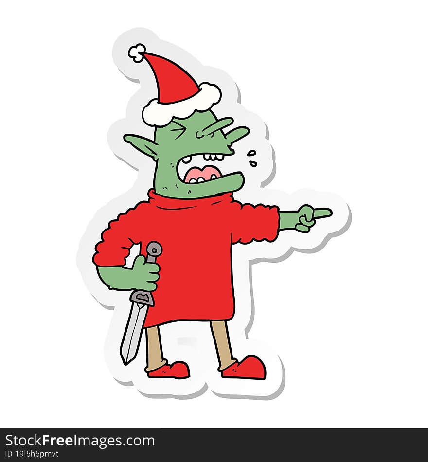 sticker cartoon of a goblin with knife wearing santa hat