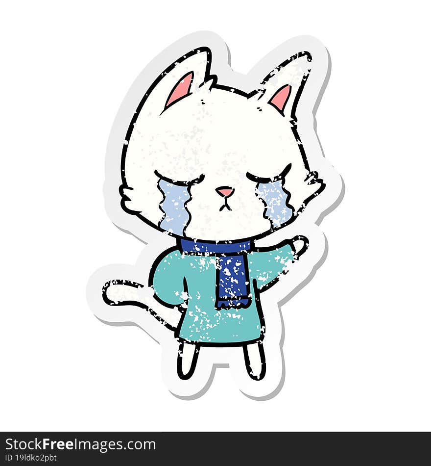 distressed sticker of a crying cartoon cat wearing winter clothes