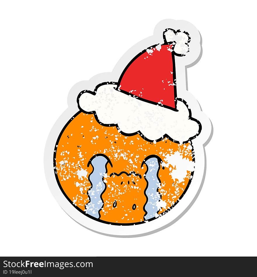 hand drawn distressed sticker cartoon of a orange wearing santa hat