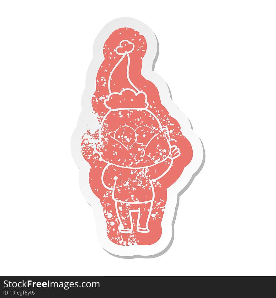 cartoon distressed sticker of a bald man staring wearing santa hat