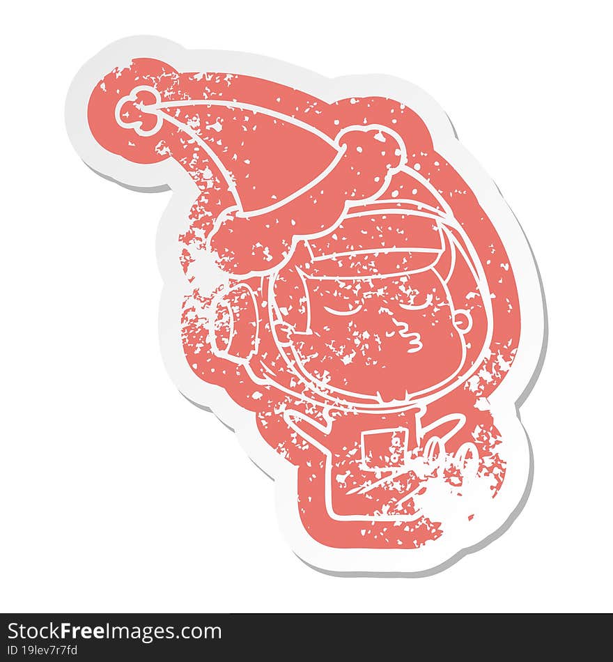 cartoon distressed sticker of a confident astronaut wearing santa hat