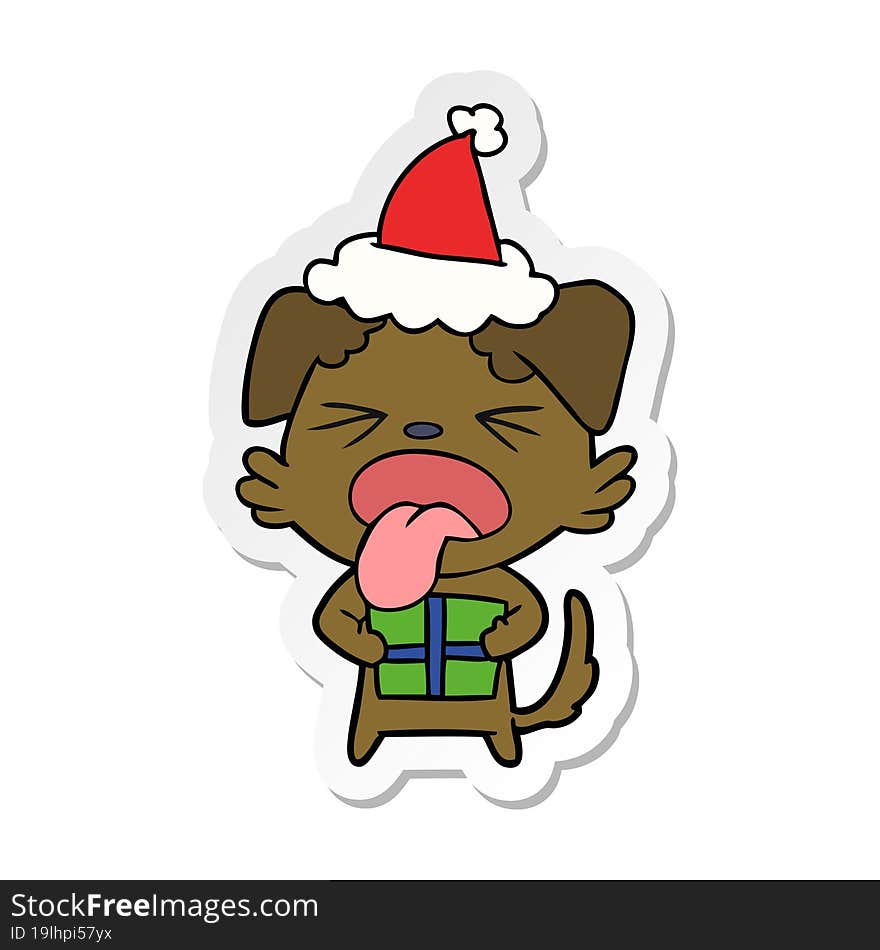 hand drawn sticker cartoon of a dog with christmas present wearing santa hat