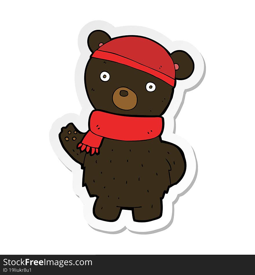 sticker of a cartoon black bear in winter hat and scarf