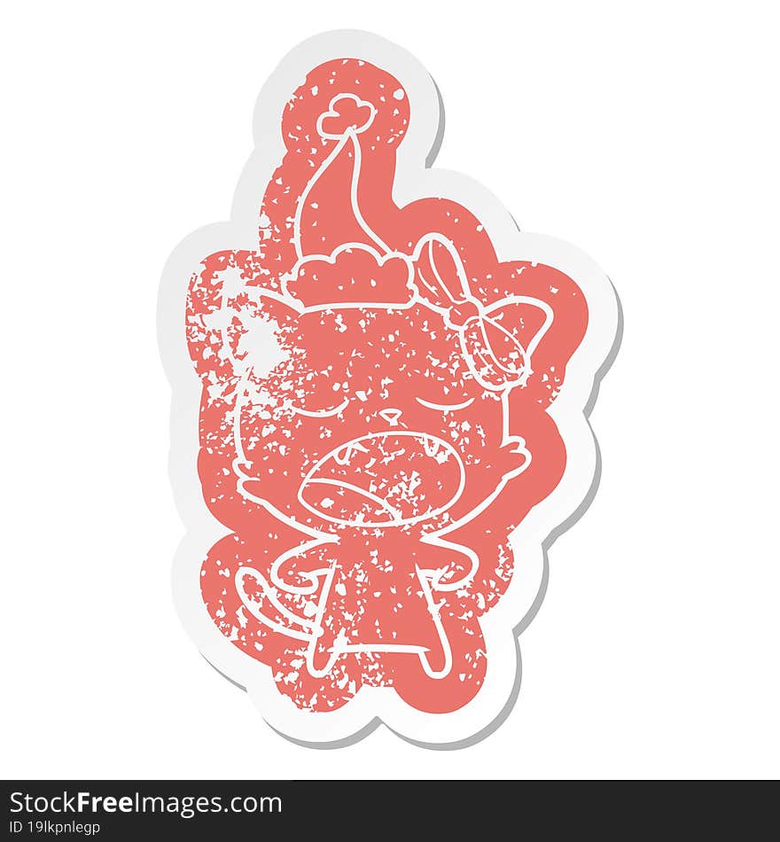 cartoon distressed sticker of a yawning cat wearing santa hat