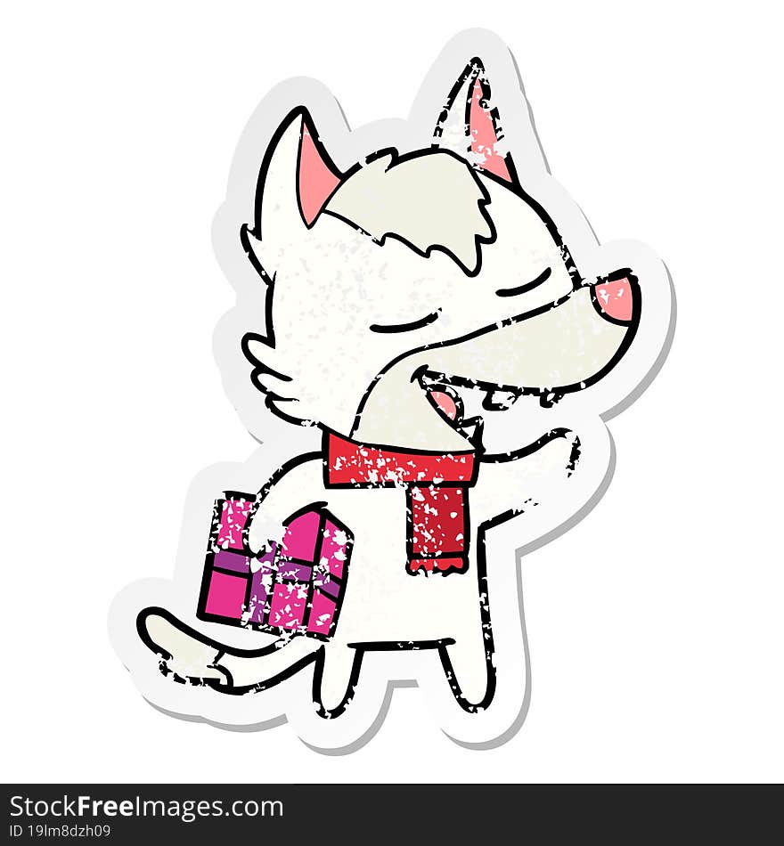 distressed sticker of a cartoon wolf with christmas present laughing