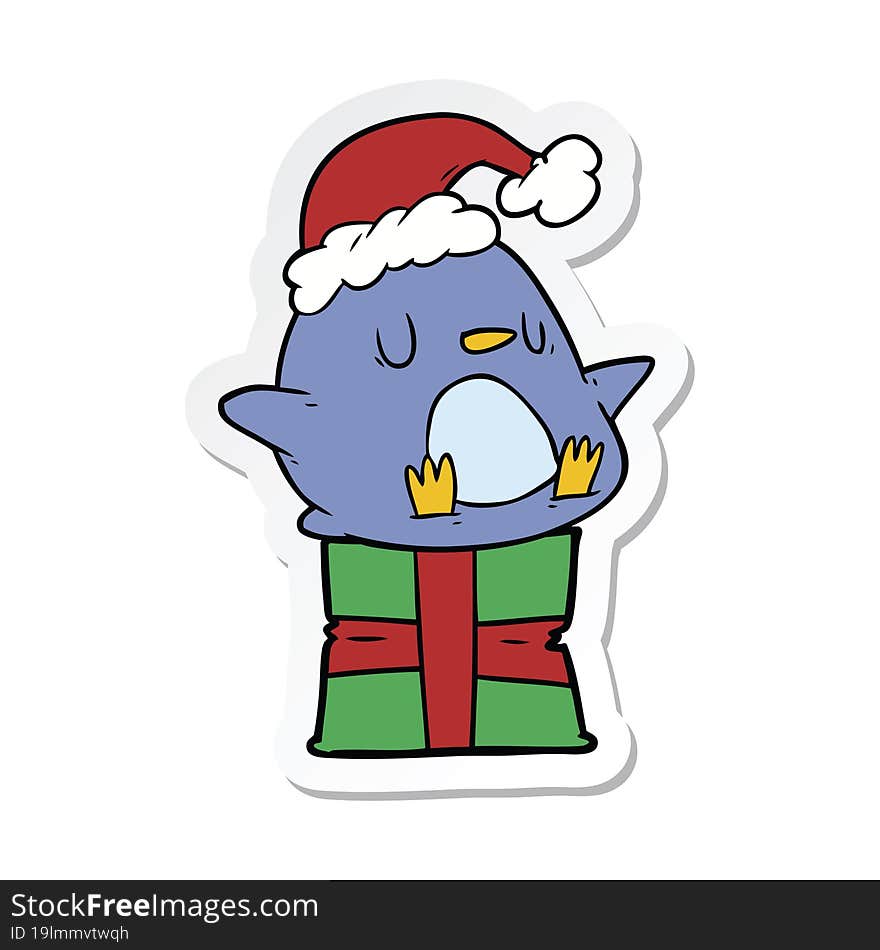 sticker of a cute cartoon penguin sitting on gift