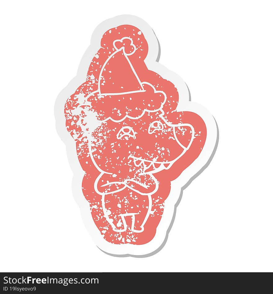 quirky cartoon distressed sticker of a bear showing teeth wearing santa hat