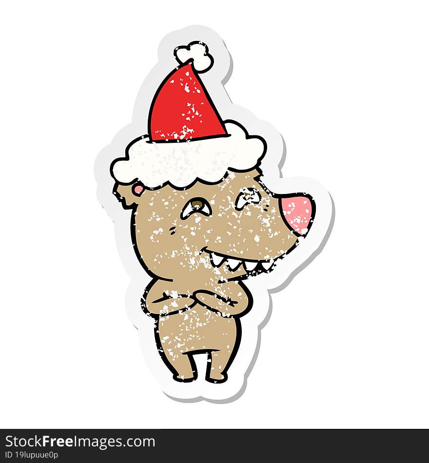 distressed sticker cartoon of a bear showing teeth wearing santa hat