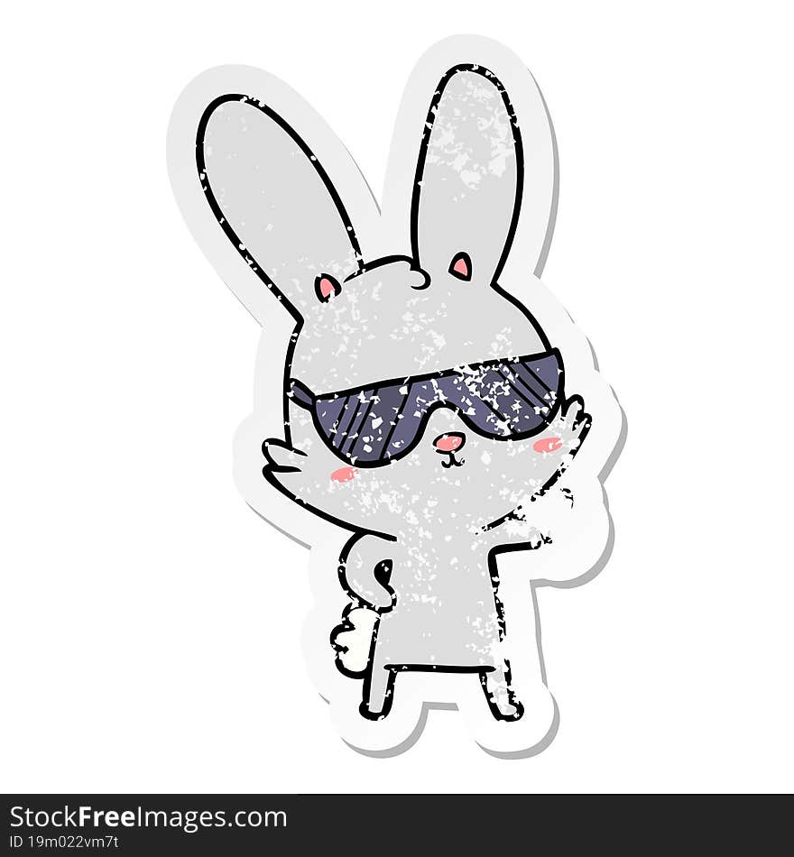 distressed sticker of a cute cartoon rabbit wearing sunglasses