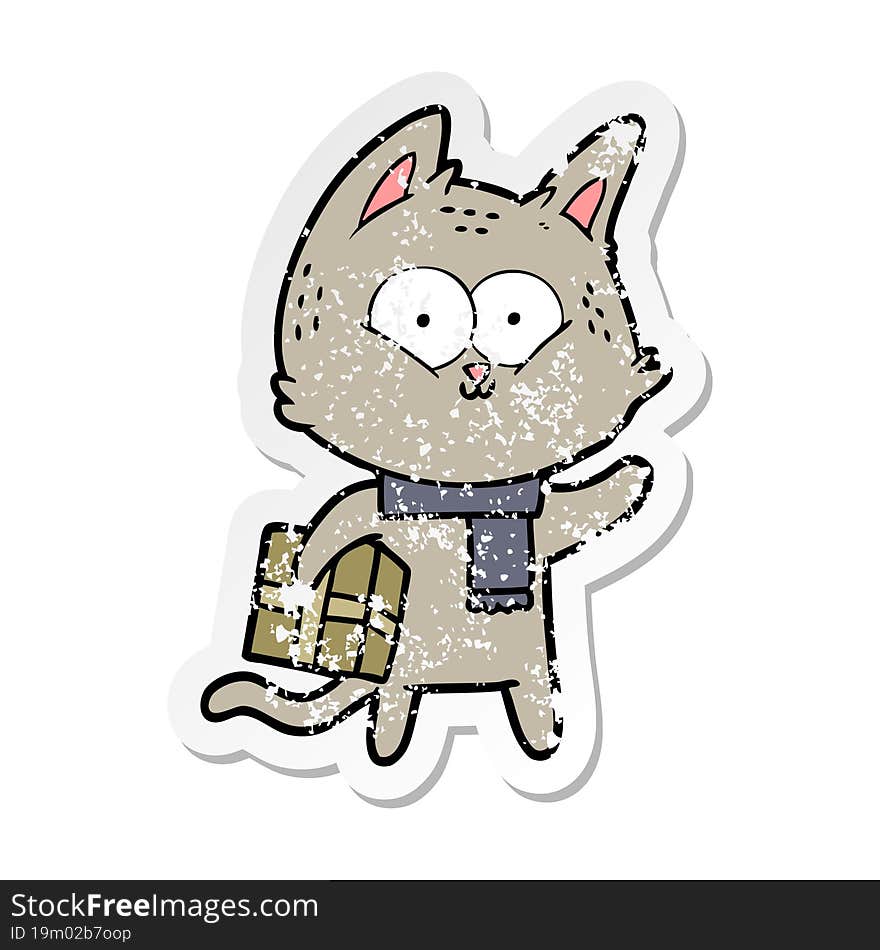 distressed sticker of a cartoon cat holding christmas present