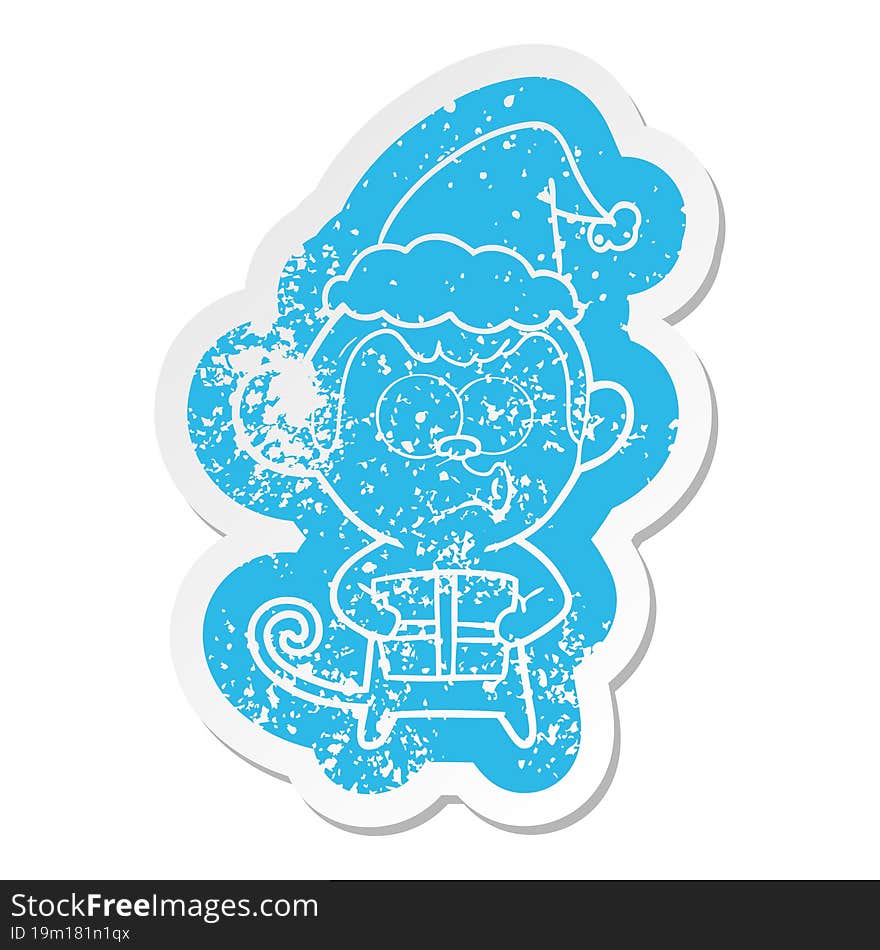 cartoon distressed sticker of a christmas monkey wearing santa hat