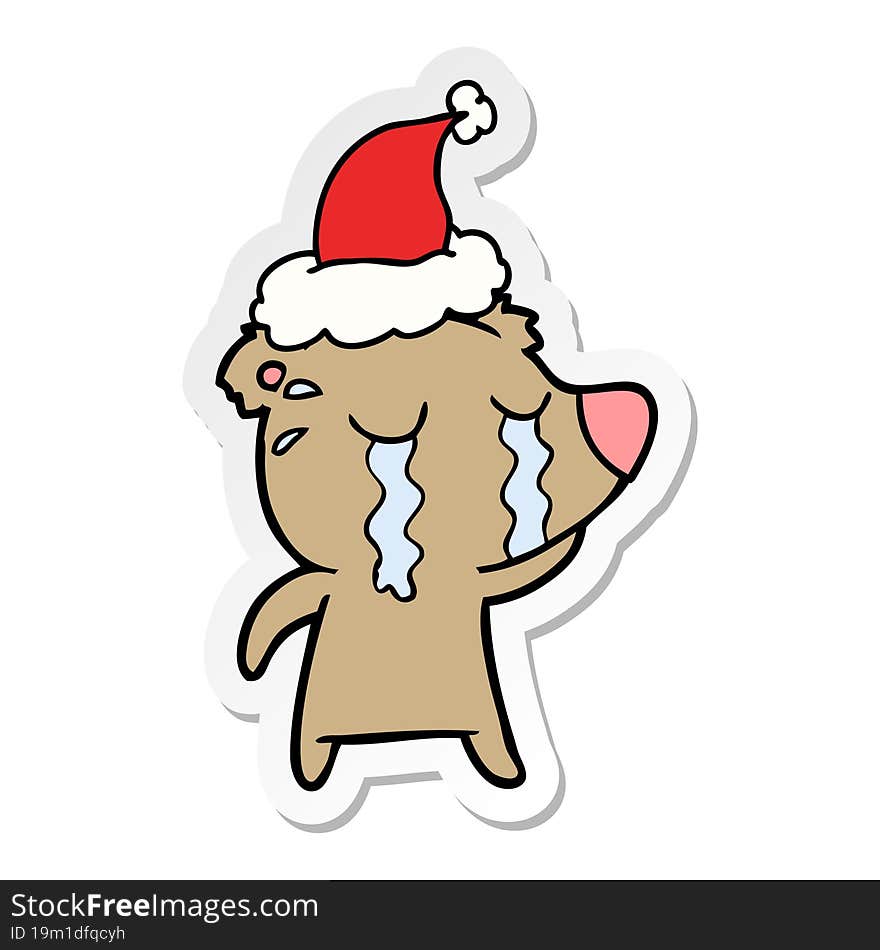 sticker cartoon of a crying bear wearing santa hat