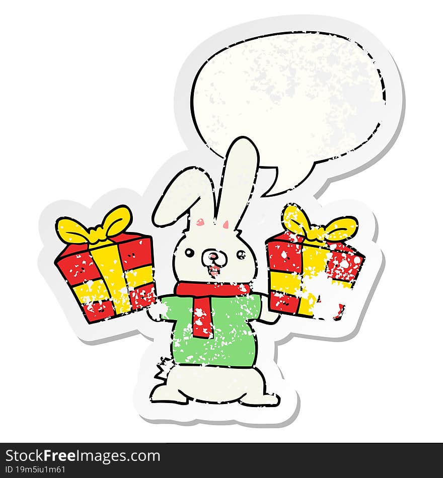 cartoon rabbit with christmas presents with speech bubble distressed distressed old sticker. cartoon rabbit with christmas presents with speech bubble distressed distressed old sticker