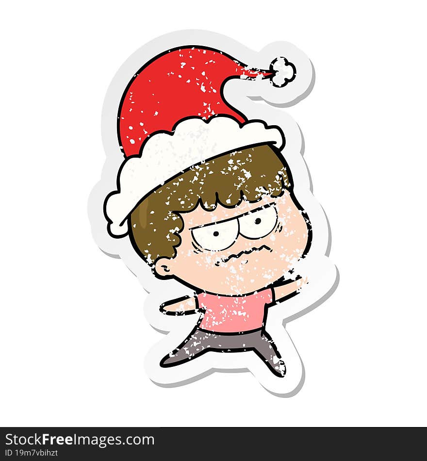 hand drawn distressed sticker cartoon of a annoyed man wearing santa hat