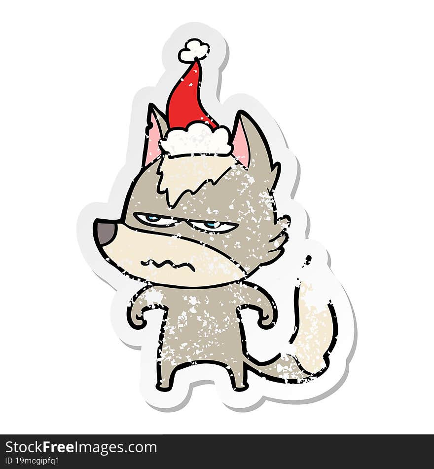 distressed sticker cartoon of a annoyed wolf wearing santa hat