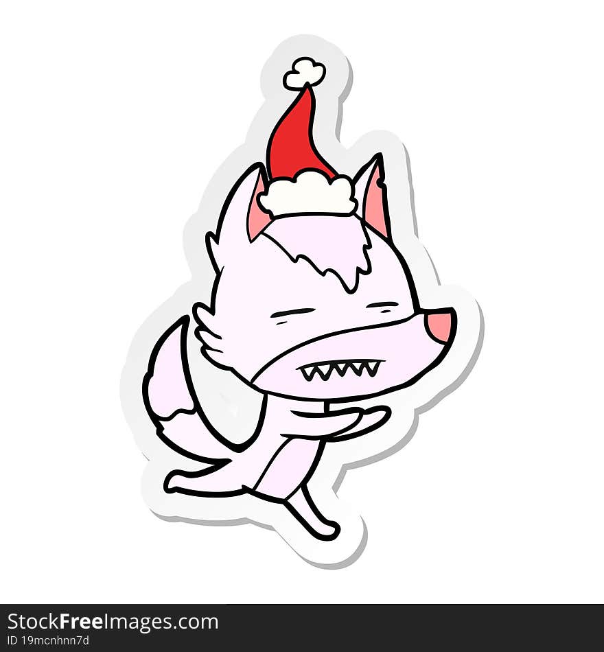 sticker cartoon of a wolf showing teeth wearing santa hat