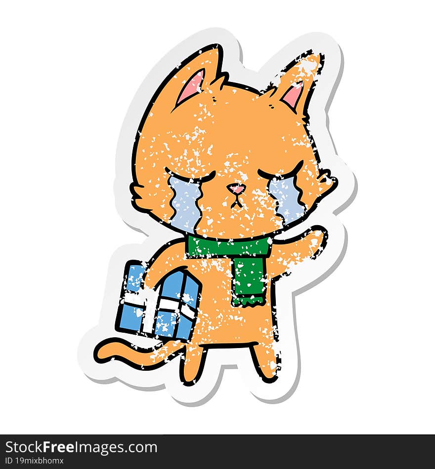 Distressed Sticker Of A Crying Cartoon Cat Holding Christmas Present