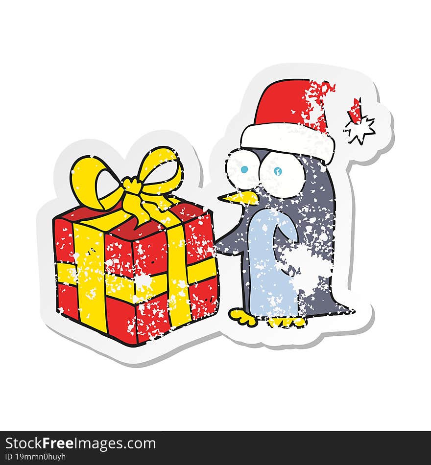 Retro Distressed Sticker Of A Cartoon Christmas Penguin With Present